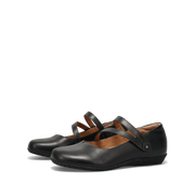 Taos Women's Banter flat in black leather, three-quarter rear view of the pair