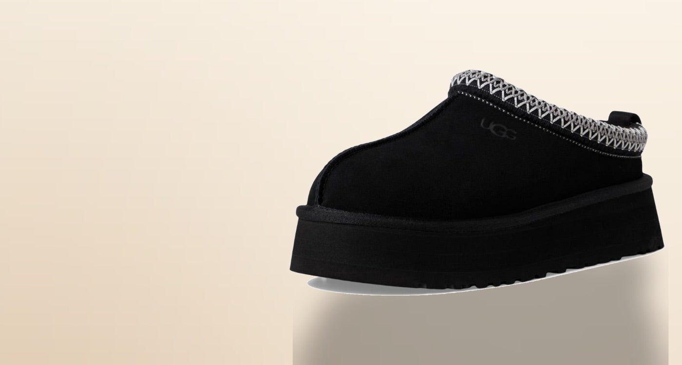 Black UGG Tazz platform slipper on a warm neutral background